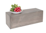 A white bowl filled with fresh red radishes and green leaves sits atop a rectangular gray-washed Aspen Riser, set against a plain white background.