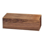 A rectangular walnut knife block with a smooth finish and visible natural wood grain. Several narrow slots are cut into the top surface, designed to hold knives securely. The block rests on a white background like a refined display crate.
