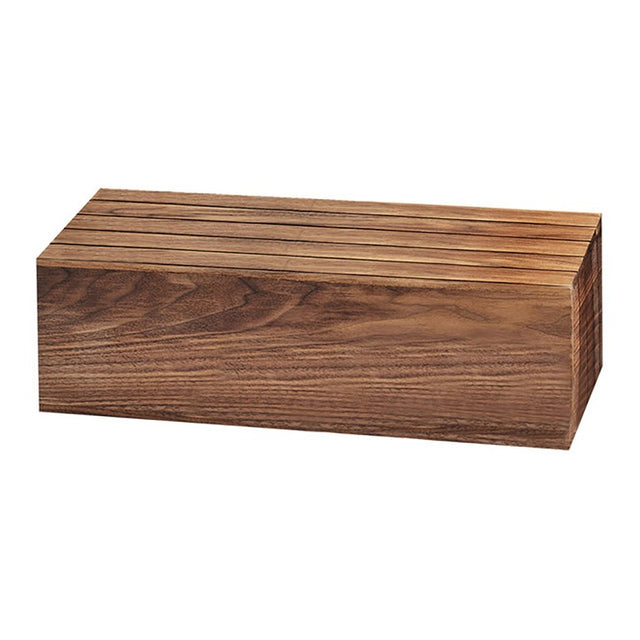 A rectangular walnut knife block with a smooth finish and visible natural wood grain. Several narrow slots are cut into the top surface, designed to hold knives securely. The block rests on a white background like a refined display crate.