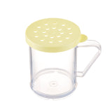 A clear plastic BPA free mug with a yellow lid featuring multiple round holes. The mug has a large handle on the right side and sits on a flat surface—an ideal dredge shaker for sprinkling powdered ingredients.