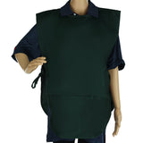 A mannequin in a dark blue collared shirt wears a dark green, machine washable cobbler apron with side ties. The apron, made from a durable poly-cotton blend, covers the torso and upper legs; one arm is bent while the other rests by its side.