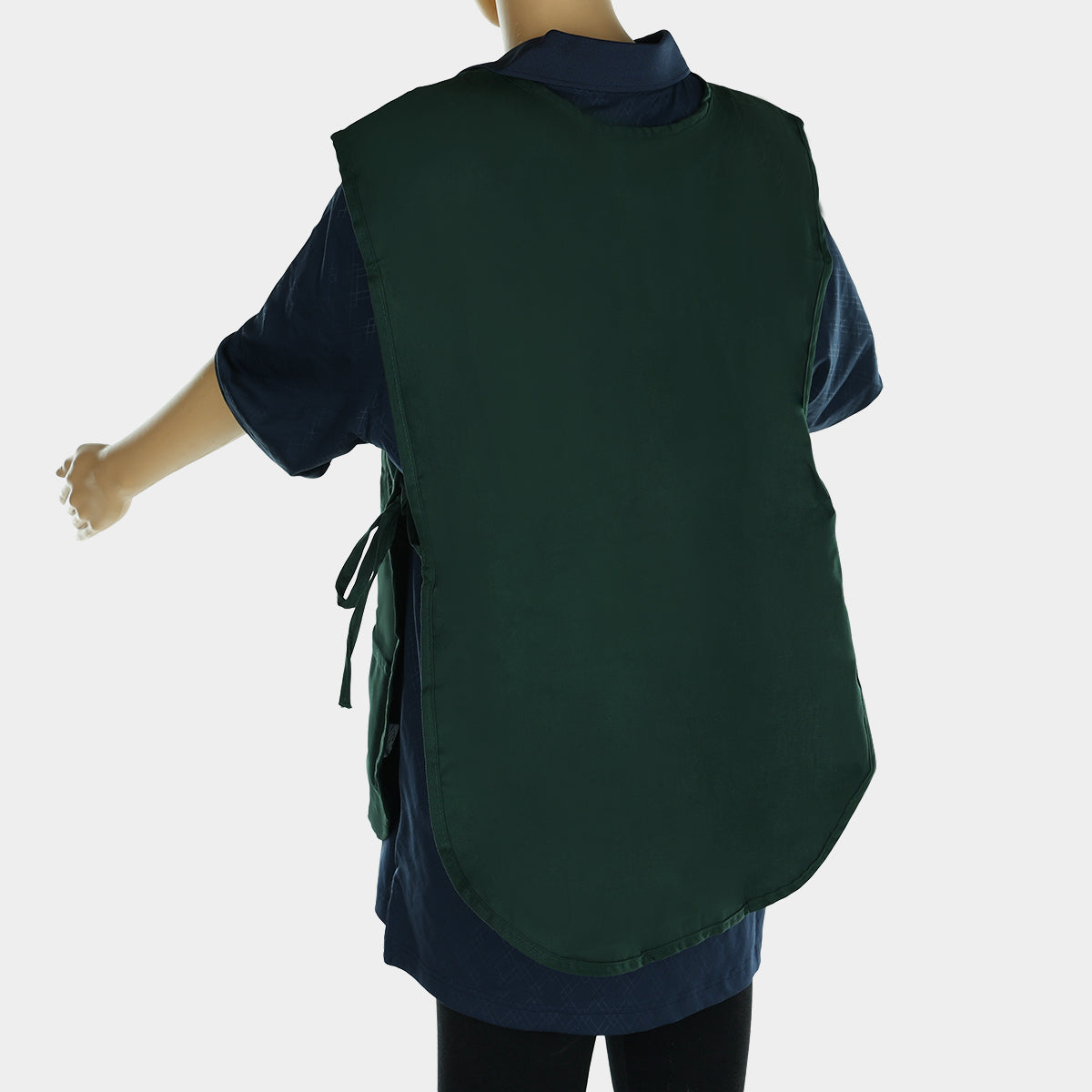 A mannequin displays a dark green cobbler apron, crafted from a durable poly-cotton blend and tied at the sides. The apron covers the upper body to the thighs over a dark shirt. The mannequin’s right arm is bent outward against a white background.