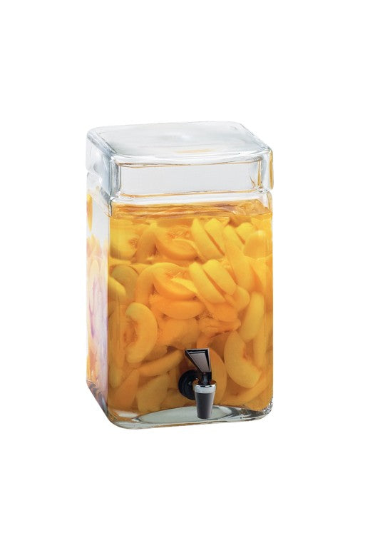 A clear, square 2-gallon BPA Free infusion dispenser with a spigot is filled with sliced yellow peaches in liquid. The dispenser, featuring a glass lid, is set against a plain white background.