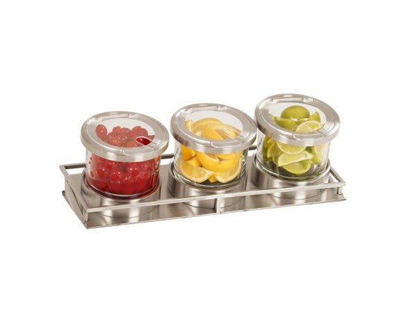 Three glass jars with metal lids are arranged on a stainless steel tray. The jars contain red cherries, yellow lemon slices, and green lime wedges—perfect for a cold condiment display and commonly used to store cocktail garnishes.