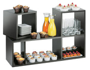 A black Cal-Mil Midnight Bamboo Library Display shelf holds muffins, desserts, orange and yellow juice in carafes, stacked plates, clear glasses, and assorted mini pastries—neatly arranged for a buffet or catered event.
