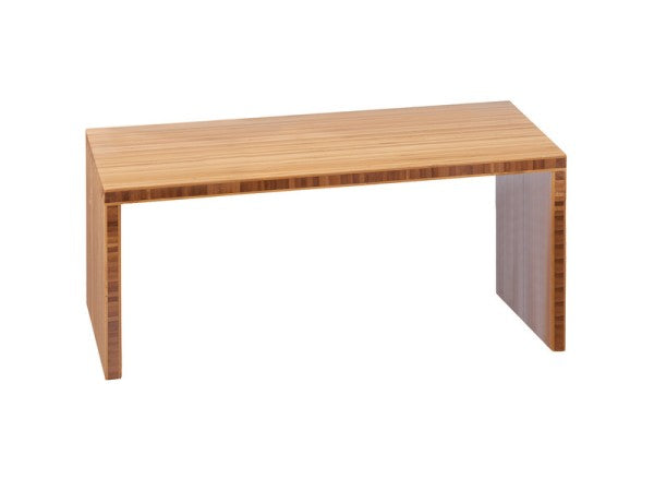 A simple, rectangular Cal-Mil wooden table with a smooth, flat top and two solid side supports. Featuring a light bamboo finish and minimalist, modern design, this step riser has no visible drawers or decorative elements.