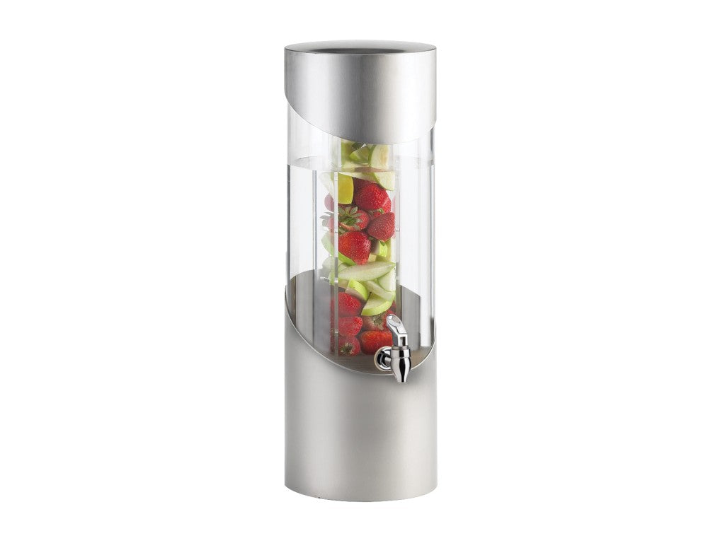 A tall, cylindrical beverage dispenser features an acrylic tank with a silver metallic base and lid. Inside, sliced green apples and whole strawberries are stacked in the central infusion chamber. A spigot is conveniently placed on the lower front.