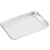 A shiny, rectangular 1/8 size stainless steel tray with slightly raised, rounded edges is shown on a white background. The tray is empty and has a smooth, reflective surface.