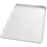 A full size, rectangular perforated aluminum sheet pan with slightly raised edges is shown on a white background. The small holes across the flat surface allow for optimal airflow during baking.