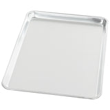 A shiny, half size aluminum sheet pan with raised edges on all sides, shown empty on a white background. The tray has slightly rounded corners and a smooth, reflective surface.