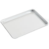 A plain, rectangular, 1/4 size aluminum bun sheet pan with raised edges on all sides sits empty on a white background. Its smooth, reflective surface and angled position highlight its depth and sturdy construction.