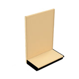 A beige metal store display fixture with a perforated pegboard back and a flat shelf at the bottom. Reminiscent of an ivory cabinet, it stands upright on a black base and is photographed against a plain white background.