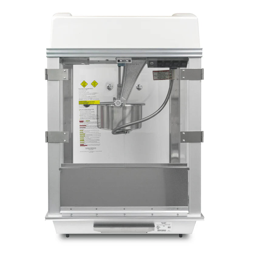 Front view of the Whiz Bang Popcorn Machine, a countertop popcorn machine featuring a stainless steel kettle in the center, clear glass door, stirring rod, control panel, warning labels on the back wall, stainless steel frame, and a white top.