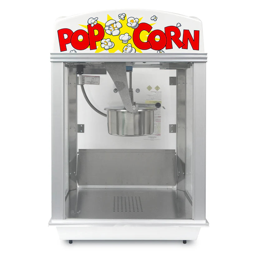 A silver and white Whiz Bang Popcorn Machine with a clear glass front. The top has a bold POP CORN sign and cartoon popcorn illustrations. Inside, a stainless steel kettle hangs in the center. This countertop popcorn machine is empty and clean.