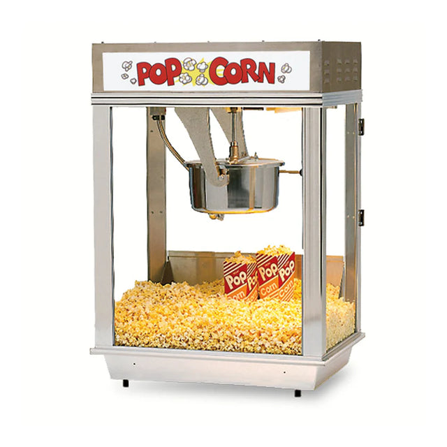 A classic countertop popcorn machine with glass sides displays a 12 oz. Unimaxx kettle inside and two red-striped boxes filled with popcorn. The bottom is lined with freshly popped yellow popcorn, beneath a “POP CORN” sign adorned with fun graphics.