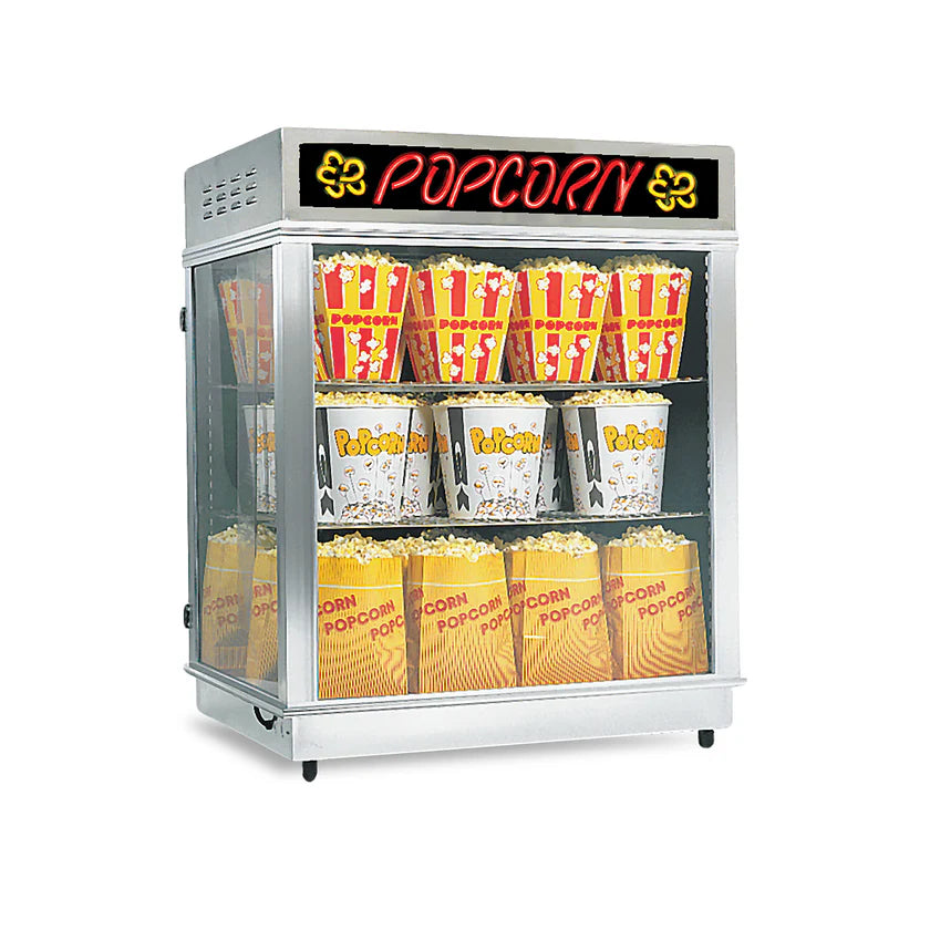 A glass popcorn display case with a black and red POPCORN sign on top, featuring a shelf warmer to keep several large, yellow-and-red-striped popcorn tubs and bags fresh on two shelves inside the case.
