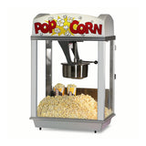 A Deluxe Whiz Bang Popcorn Machine filled with freshly popped popcorn. Two tubs are partially buried inside, with glass sides, a metal Unimaxx kettle, and a sign on top that says POP CORN alongside popcorn illustrations.