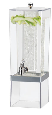 A tall, clear 3-gallon beverage dispenser filled with ice, featuring a chrome spigot at the front and green lettuce leaves as garnish along the inner top edge. The modern, angular design sits atop a matching clear base.