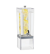 A tall, clear Econo Beverage Dispenser with a 3 gallon capacity is filled with water and stacked lemon slices. Featuring an infusion chamber and a silver spigot near the base, it sits atop a translucent stand against a plain white background.