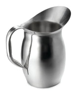 A shiny Bell Water Pitcher with a wide, rounded body, sturdy handle, and elongated curved spout sits empty on a plain white background. This stainless steel pitcher is designed for pouring liquids and is dishwasher safe.