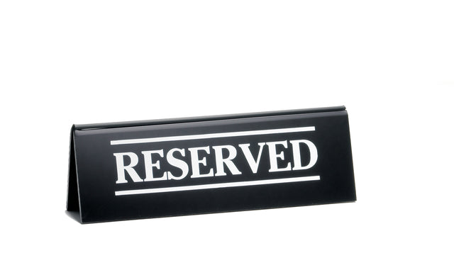 A black acrylic table tent reserved sign features the word "RESERVED" in bold white capital letters, framed by two horizontal white lines, and is isolated on a white background.