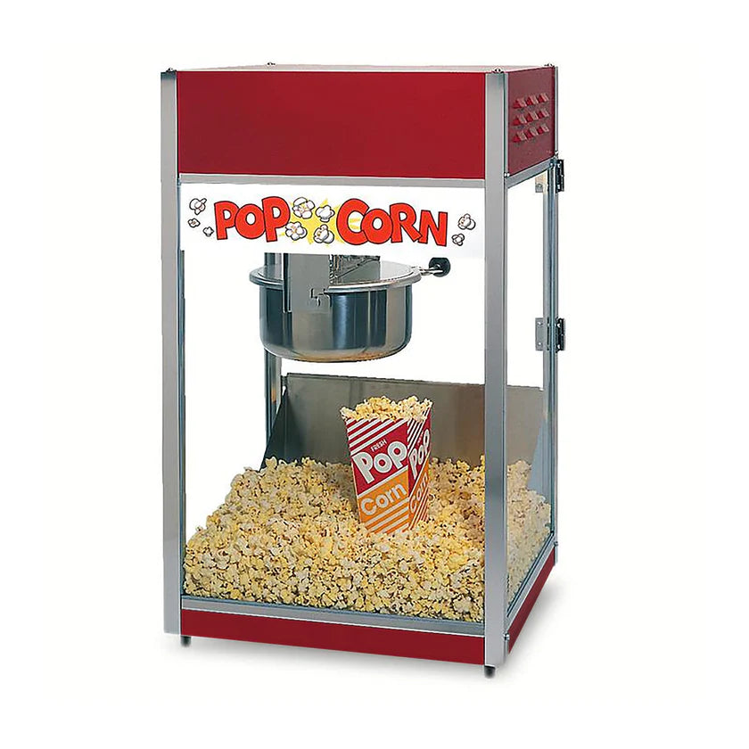 A red and silver countertop popcorn machine filled with popped popcorn. Inside is a large stainless steel kettle and a single striped popcorn container. The sign reads POPCORN with cartoon popcorn illustrations.