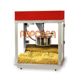 A metal Econo 14 oz Popcorn Popper with a red top and glass sides is filled with yellow popcorn. The word POPCORN is printed in large, stylized red and yellow letters on the front glass panel above its stainless steel kettle.