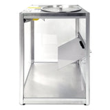 A rectangular, transparent ballot box with a metallic frame, reminiscent of a Gold Medal Products Servalot chip warmer. The top has a circular lid with a slit for ballots, and one side features a hinged, partially open panel. The empty box stands on a white background.