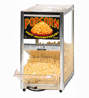 A Gold Medal Products Servalot Warmer filled with popped popcorn. The countertop warmer has a clear glass front, bold “POPCORN HOT-NUTRITIOUS!” sign, and a hinged door at the bottom for easy dispensing.