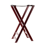 A dark wood folding luggage rack with a mahogany finish features two X-shaped legs and two black nylon, slip-proof support straps across the top for holding suitcases. The background is plain white.