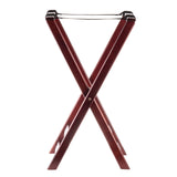 A folding wooden luggage rack with a rich mahogany finish, featuring dark reddish-brown crossed legs and two black slip-proof support straps on top. The rack stands open, viewed from the front against a white background.