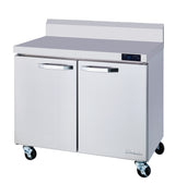 A two-section stainless steel refrigerated work top with two doors, digital temperature display, metal handles, backsplash, and four caster wheels. Its smooth, reflective exterior is branded “Rhinair” in the lower right corner.