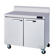 A two-section stainless steel refrigerated work top with two doors, digital temperature display, metal handles, backsplash, and four caster wheels. Its smooth, reflective exterior is branded “Rhinair” in the lower right corner.