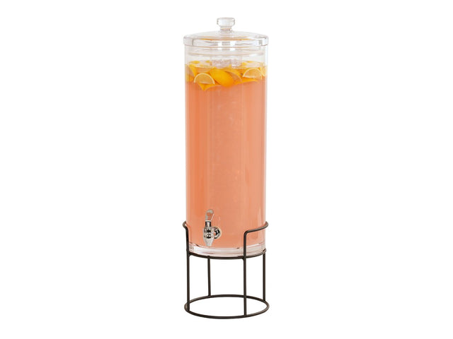 A tall, clear 3 gallon beverage dispenser with a spigot, filled with pink liquid and floating lemon slices, sits on a black metal stand. The dispenser has a glass lid and is isolated on a white background.