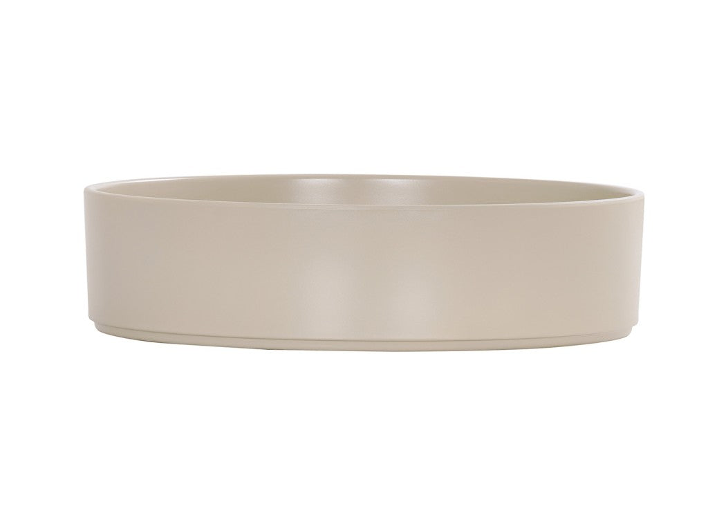 A plain, round, beige Hudson Bowl with straight, smooth sides and a flat base. The minimalist melamine bowl features a simple design, is dishwasher safe, and sits against a white background that highlights its neutral color and clean lines.