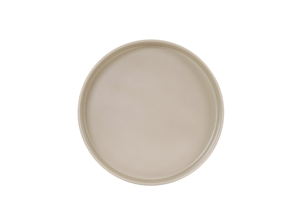 A round, light beige Hudson Bowl with a smooth, matte finish is viewed from above against a plain white background. The plate features a slightly raised rim, no visible patterns or decorations, and is dishwasher safe.