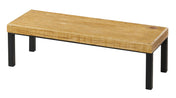A rectangular bench with a thick, rustic pine top featuring visible grain, supported by four simple black metal legs. The design is modern and minimalistic, with clean lines—reminiscent of a Cal-Mil Madera Riser—isolated on a white background.