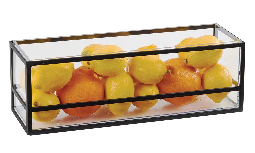 A rectangular Cal-Mil glass and metal container serves as a stunning presentation display, filled with lemons and oranges. Its clear sides and black metal edges showcase the bright fruits beautifully against a white background, perfect for any countertop riser setup.