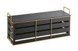 A rectangular black Cal-Mil bench with open slats on the sides and gold wire frame accents. The Empire Riser features a flat top, two handles at each end, and gold lines outlining the front and sides. It stands on four short feet against a white background.
