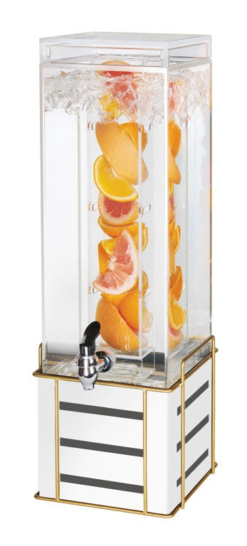 A clear, square beverage dispenser with a black spigot and gold-edged, white base. Its BPA Free infusion chamber holds orange and grapefruit slices, with bubbles and splashes visible as water fills the outer section.
