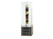The Empire Beverage Dispenser features a clear 3 gallon beverage dispenser with a spigot. Its infusion chamber holds sliced limes, cherries, and mint leaves, while the glossy black and gold grid base adds a modern, elegant touch.