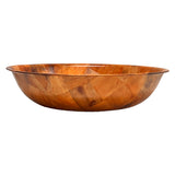 A shallow, round woven wood salad bowl with a smooth finish and a patchwork pattern of light and dark brown wood pieces, set against a plain white background.