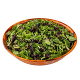 A large 14-1/2 qt. salad bowl filled with a mix of fresh, leafy salad greens, including light green and dark purple leaves, isolated on a white background.