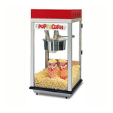 A countertop popcorn machine with a red top and glass sides is filled with freshly popped popcorn. Inside, three red and white striped Pop Corn containers sit among the popcorn on the heated corn deck at the bottom.
