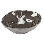 A black ceramic Marin Bowl with an irregular, wavy rim and a reflective, glossy surface. The interior features white patches that create a marbled effect, giving this melamine bowl an abstract, organic appearance.