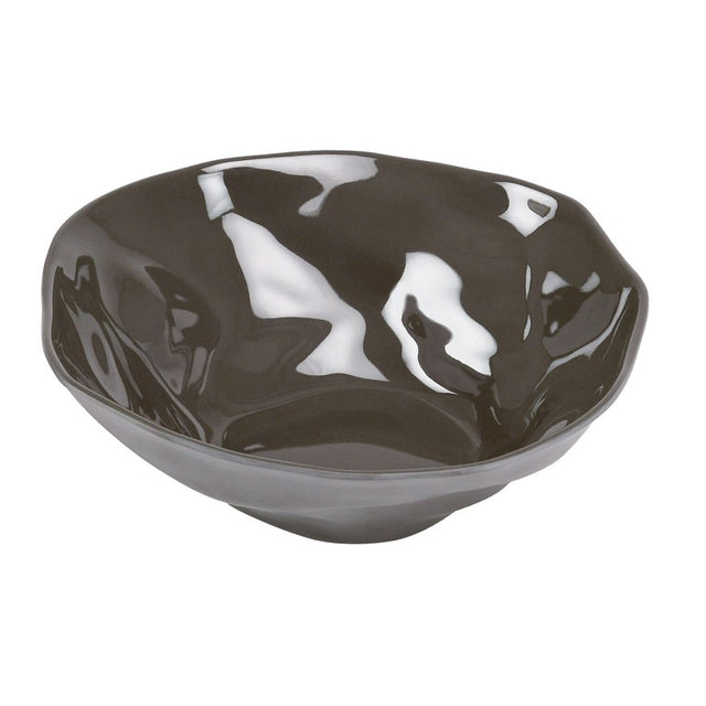 A shiny, irregularly shaped dark gray Cal-Mil Marin Bowl with a wavy rim and glossy, reflective surface, set against a plain white background. This melamine bowl has an organic, handmade appearance with smooth curves and subtle indentations.