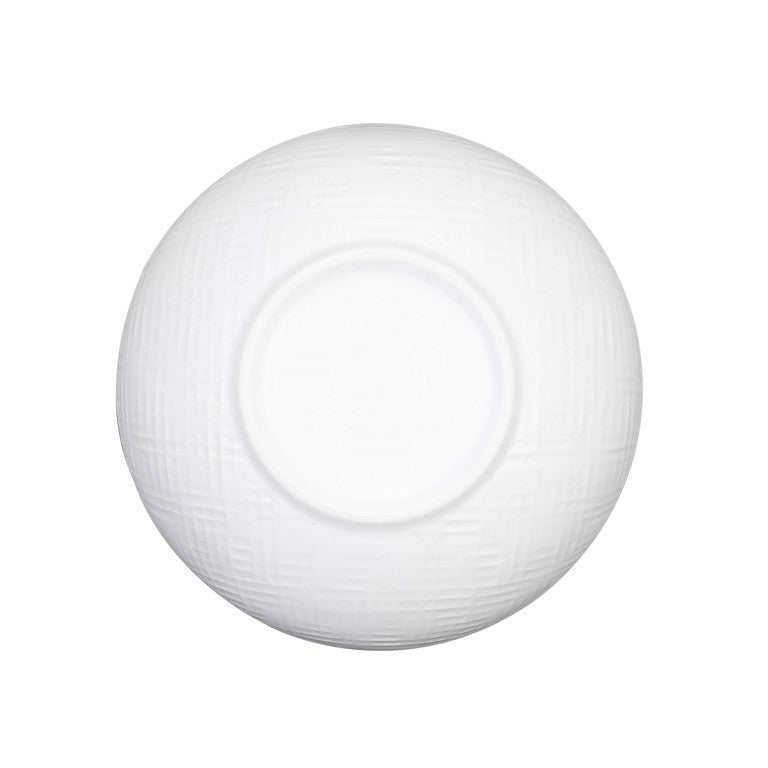 A white serving bowl, round and seen from above, features a subtle textured pattern of intersecting lines and a smooth circular center, set against a plain white background.