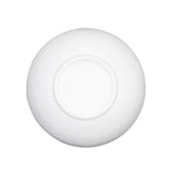 A white serving bowl, round and seen from above, features a subtle textured pattern of intersecting lines and a smooth circular center, set against a plain white background.