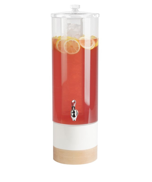 A tall, clear polycarbonate beverage dispenser filled with red drink, ice cubes, and lemon slices. It features a silver spigot, a transparent lid, a white midsection, and a light wood base against a plain white background.
