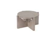 A round, light gray-washed pine wood coffee table with a thick top and a unique crossed-leg base, featuring four wide, flat panels intersecting below the tabletop. The table has a minimalist, modern design and a natural wood grain finish.